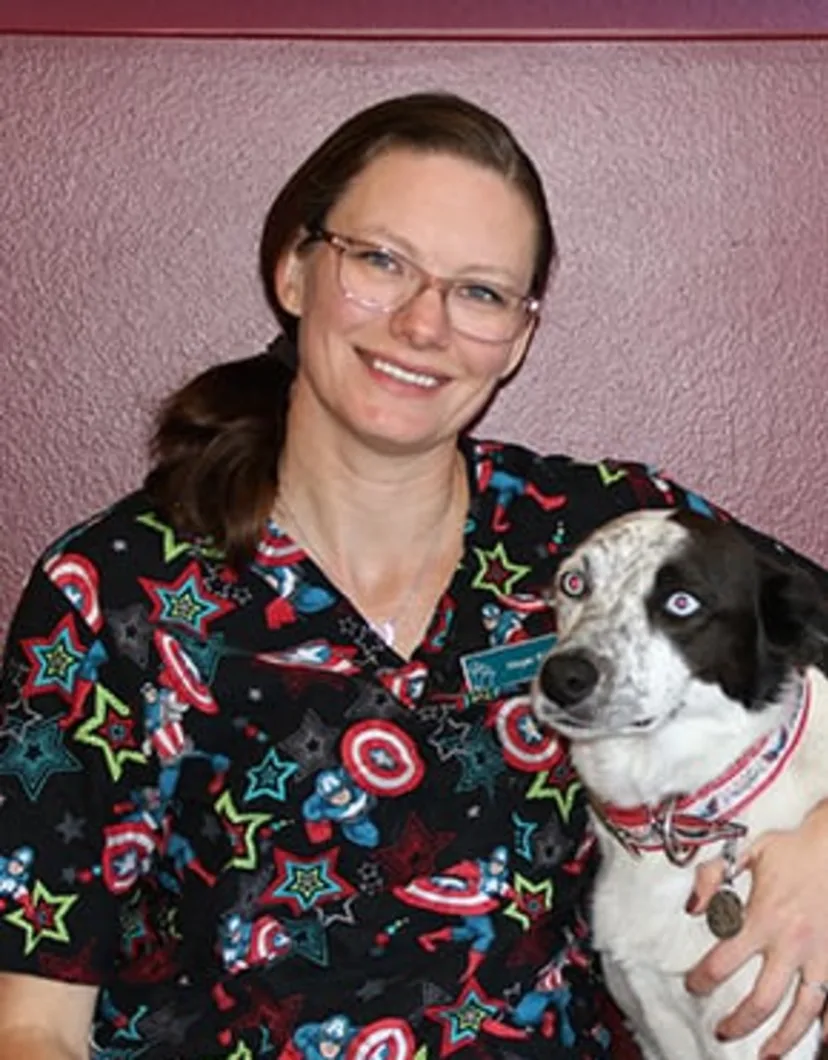 Megan smiling while holding a dog